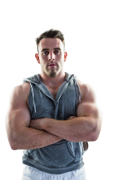 Handsome bodybuilder with arms crossed on white background