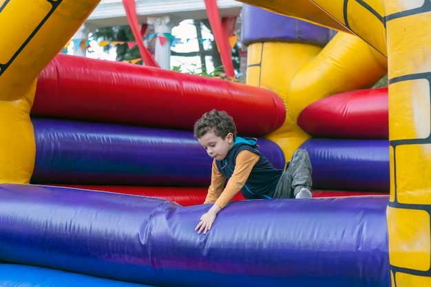 Handsome boy playing in bouncy castle