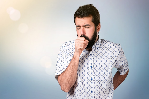 Handsome brunette man with beard coughing a lot