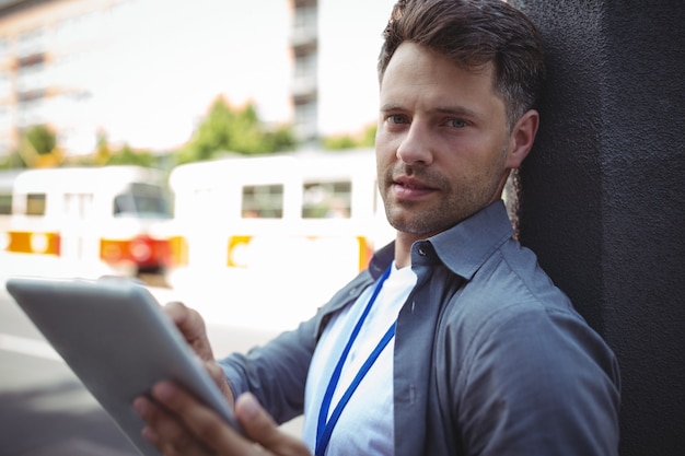 Handsome business executive using digital tablet