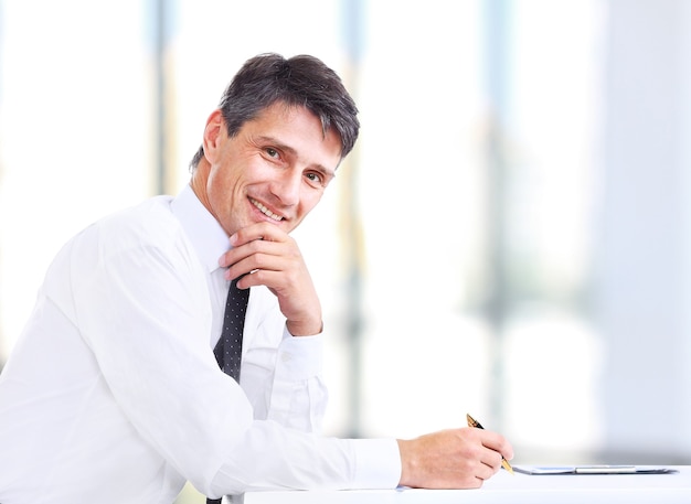 Handsome business man smiling at the office