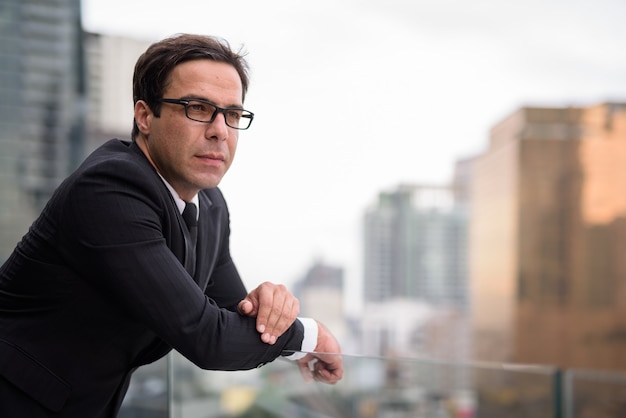 Handsome businessman against view of the city