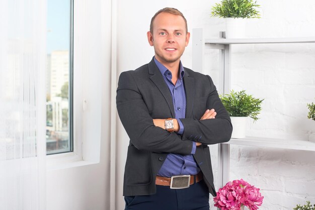 Handsome businessman confident and smiling standing in office