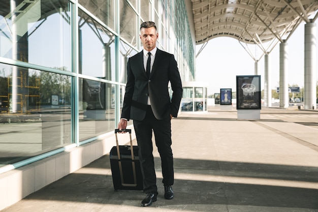 Handsome businessman dressed in suit walking