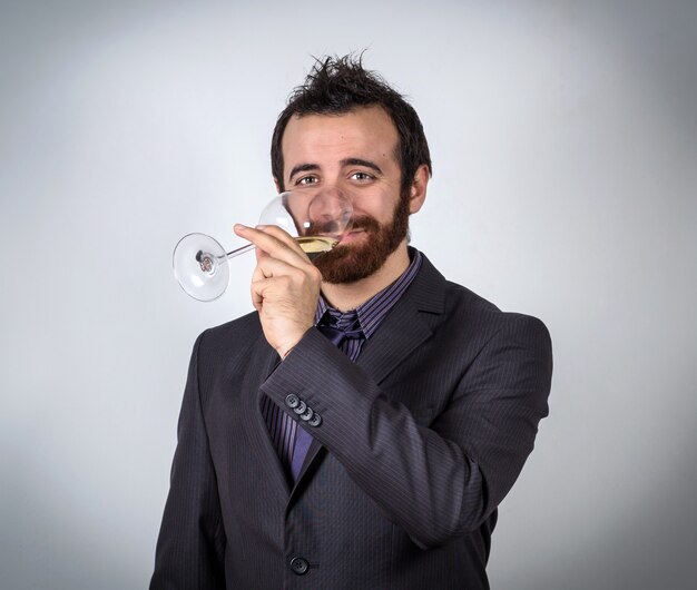 Handsome businessman drinking white wine