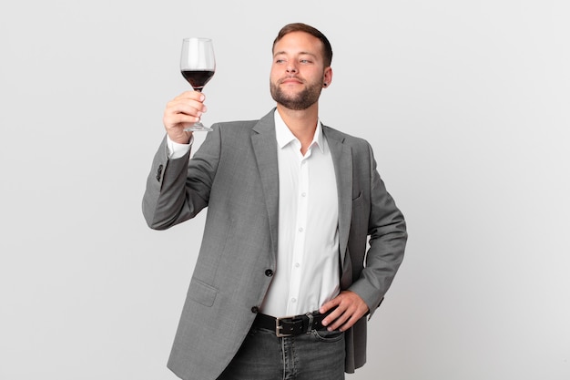 Handsome businessman having a wine