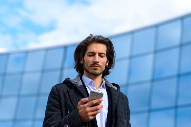 Handsome businessman holding his phone