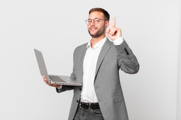 Handsome businessman holding a laptop