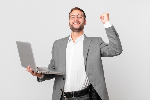 handsome businessman holding a laptop