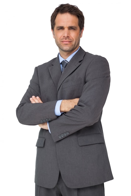 Handsome businessman looking at camera with arms crossed