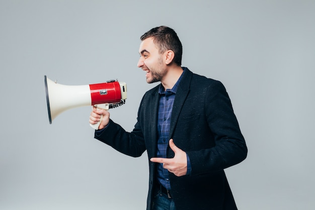 Handsome businessman shouting by megaphone isolated on white background