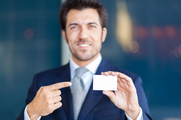 Handsome businessman showing a greeting card