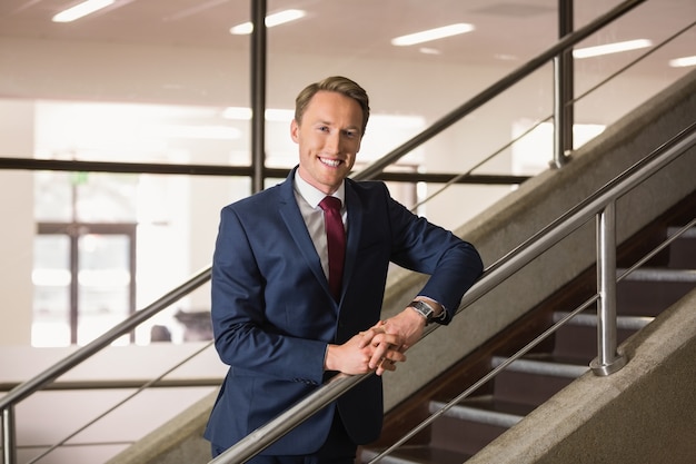 Handsome businessman standing on steps 