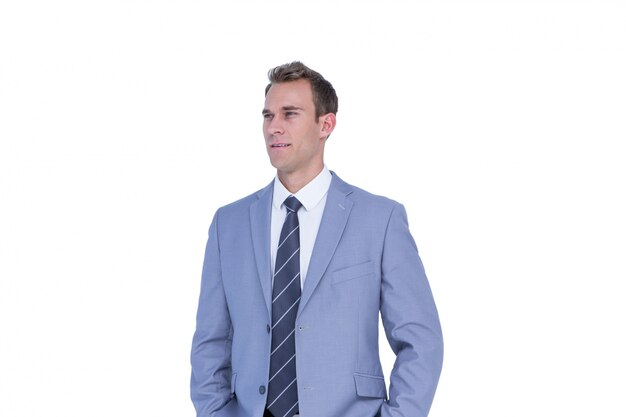 Handsome businessman standing with hands on pockets 