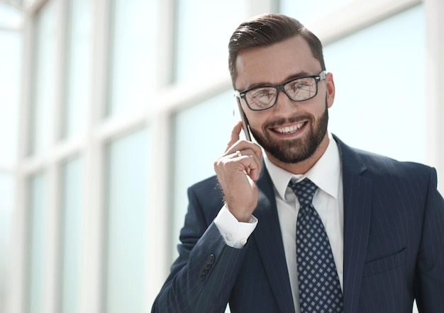 Handsome businessman talking on mobile phonephoto with copy space