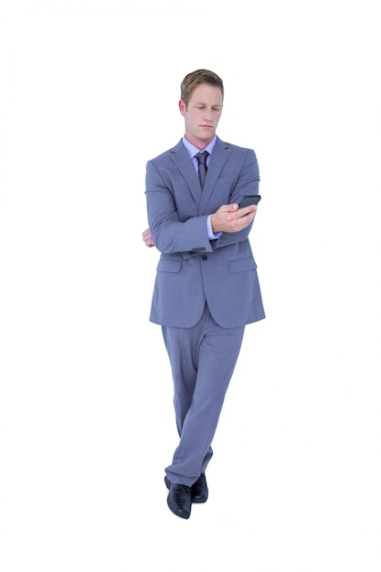 Handsome businessman texting on phone