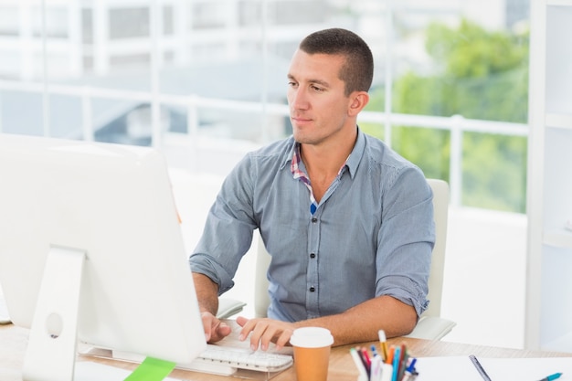 Handsome businessman typing on a computer