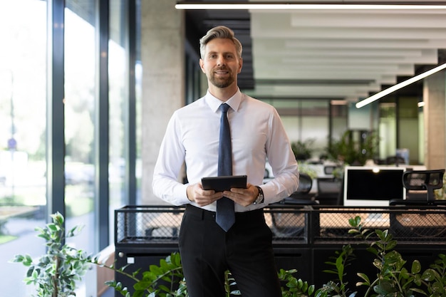 Handsome businessman using his tablet in the office