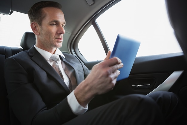 Handsome businessman using his tablet pc