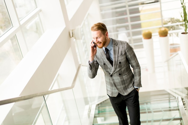 Handsome businessman using smartphone in the office