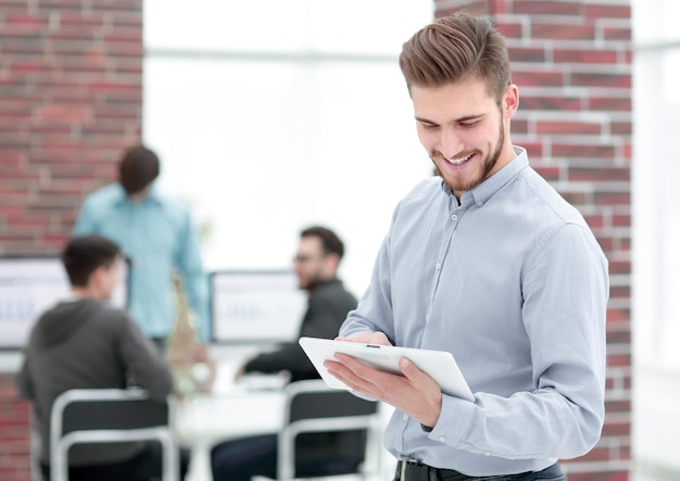 Handsome businessman using a tablet in the office