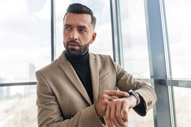 Handsome businessman watching the time while in the office