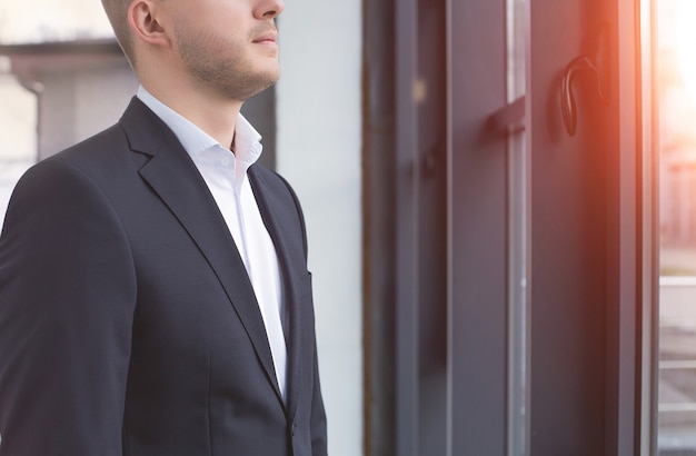 Handsome businessman wearing a black suit