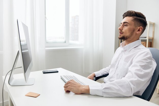 Handsome businessman in a white shirt at the office work\
executive