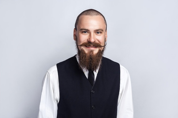 Handsome businessman with beard and handlebar mustache looking at camera with toothy smiley face