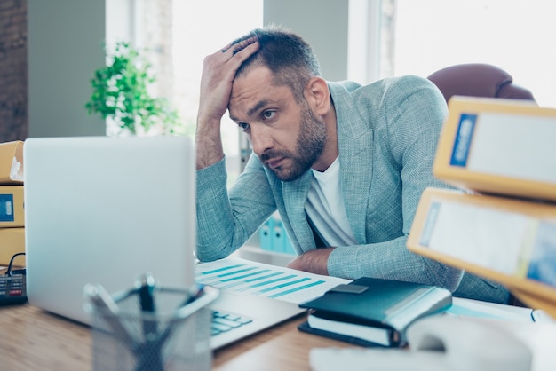 Handsome businessman with a blue jacket working in the office