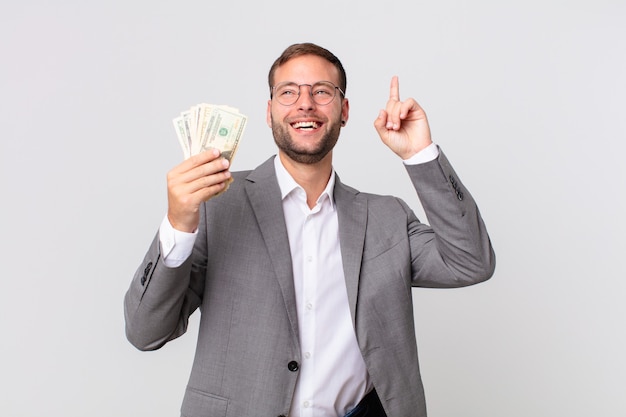 Handsome businessman with dollar banknotes