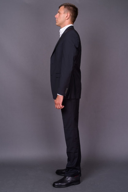 Handsome businessman with short hair against gray background