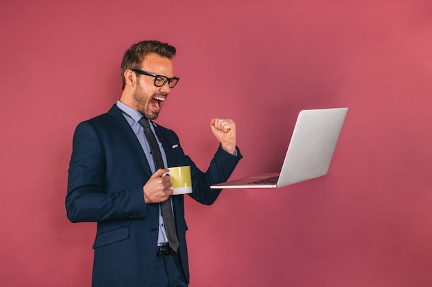 Handsome businessman working in a laptop