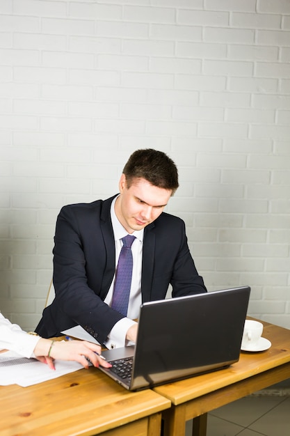 Handsome businessman working with laptop in office