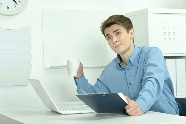 Handsome businessman working with laptop in office