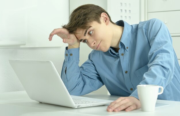 Handsome businessman working with laptop in office