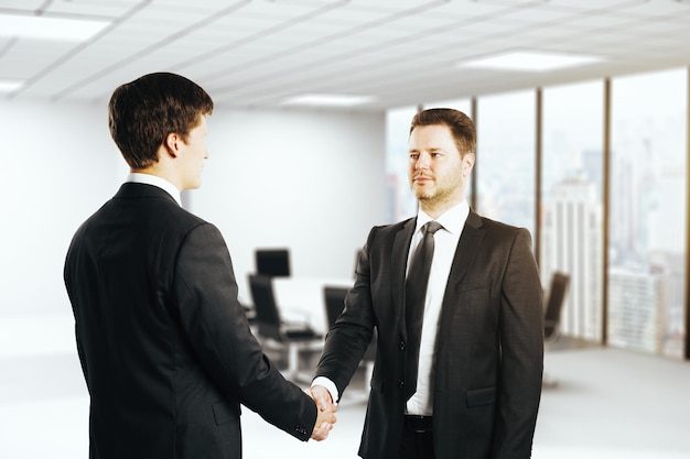 Handsome businessmen shaking hands