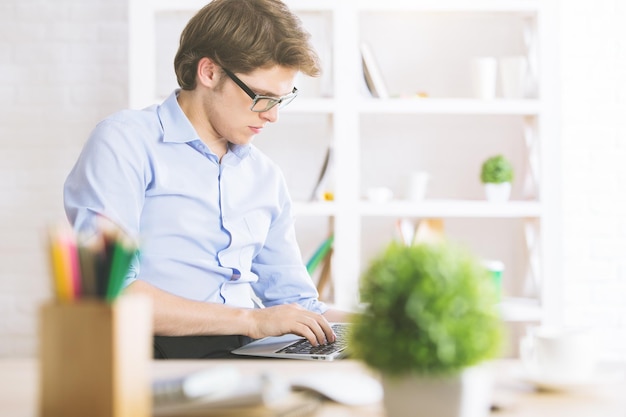 Handsome businessperson using laptop