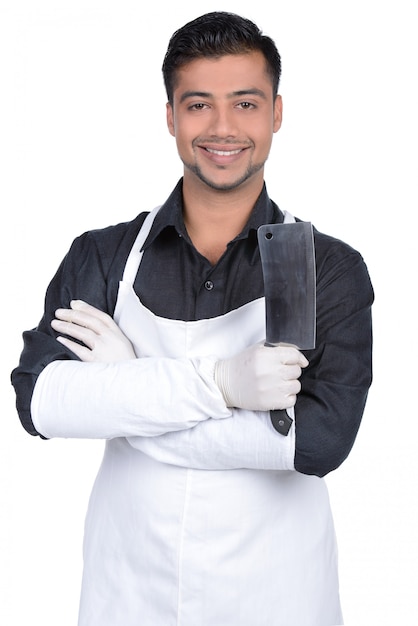 Handsome butcher smiling and holding knife.