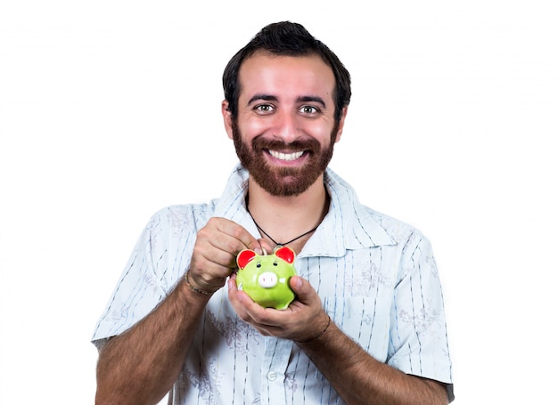 Handsome casual man with piggy bank