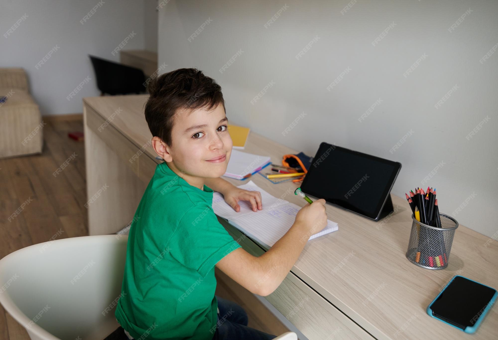 Premium Photo Handsome Caucasian 9 years old smart school boy sits at