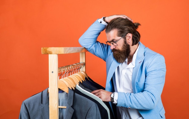 Handsome caucasian businessman with trendy hairstyle in jacket shopping