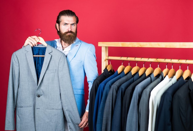 Handsome caucasian businessman with trendy hairstyle in jacket wardrobe