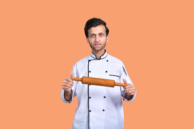 handsome chef cook holding rolling pin indian pakistani model