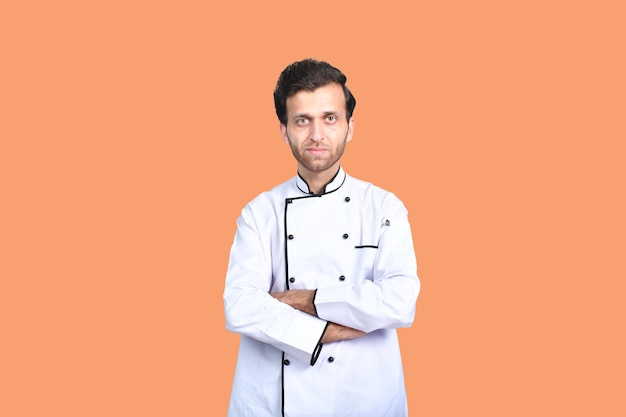 handsome chef cook white outfit isolated on orange background indian pakistani model