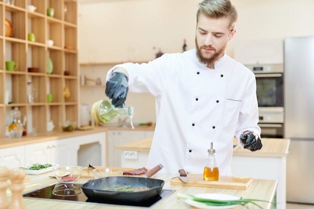 Handsome Chef Cooking in Cafe