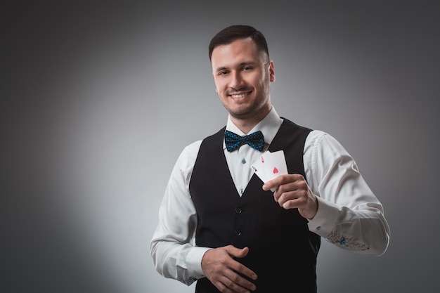 Handsome confident man holding cards looking at camera.