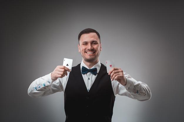 Handsome confident man holding cards looking at camera.