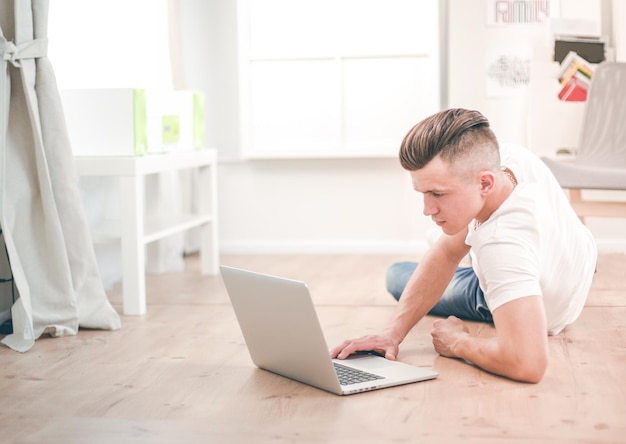 Handsome confident man sitting in armchair at home