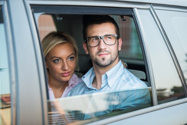 Handsome couple looking from a car